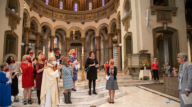 Those commissioned as lay ecclesial ministers on Saturday, Oct. 24, stand with Bishop Barry C. Knestout as their classmate, Bridgett Passauer, right, pays tribute to the work done by Bernadette Harris (black dress) for her work as director of the diocese’s Lay Ecclesial Ministry Program. (Photo/Vy Barto)